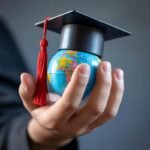 Student holding a globe — study abroad with Vital Link Consultants
